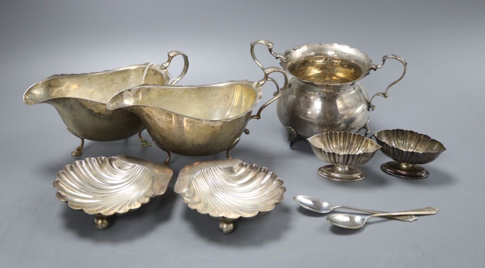 A pair of modern silver sauceboats, a George V sugar bowl, a pair of George III sugar tongs, a pair of Victorian scallop dishes and a p